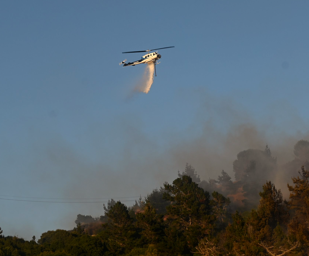Helicopters assist ground crews fighting Dornan Drive fire