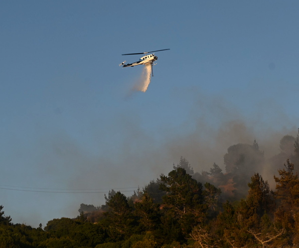 Helicopters assist ground crews fighting Dornan Drive fire